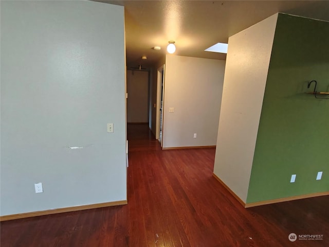 corridor with hardwood / wood-style floors