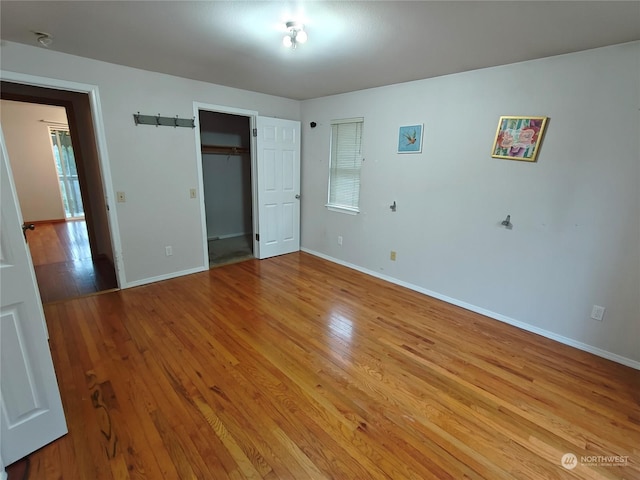 unfurnished bedroom with light wood-type flooring