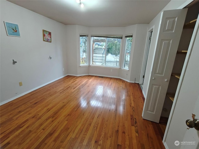 unfurnished room featuring hardwood / wood-style flooring