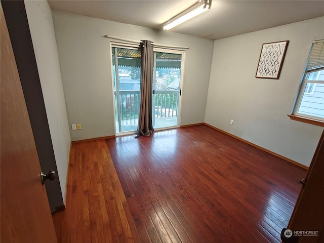 unfurnished room with dark wood-type flooring