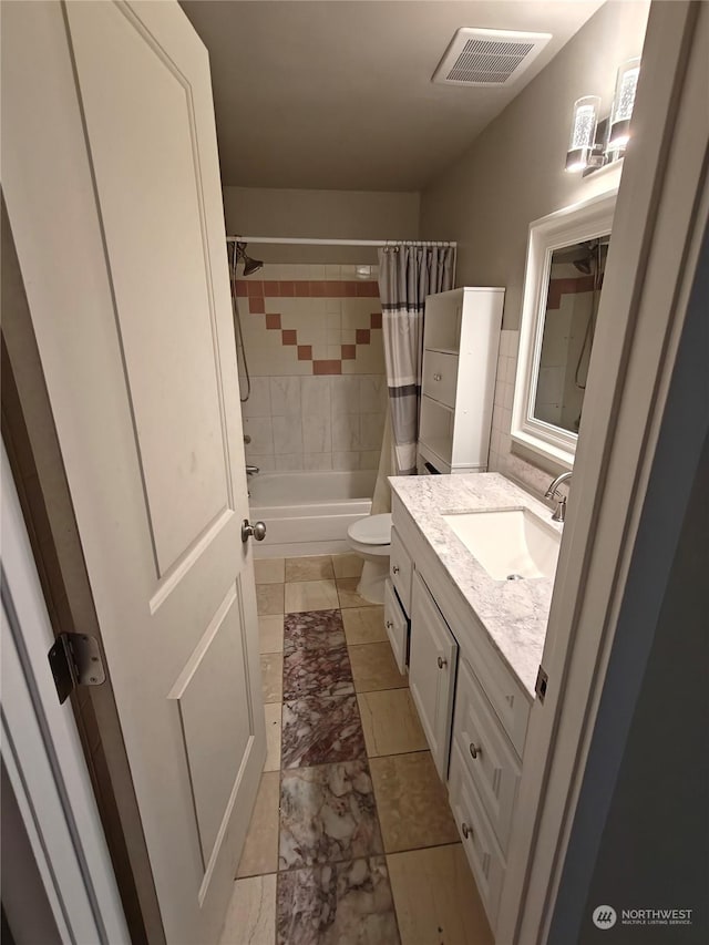 full bathroom with vanity, toilet, and shower / bath combo with shower curtain