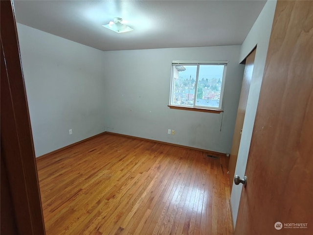 spare room featuring light hardwood / wood-style floors