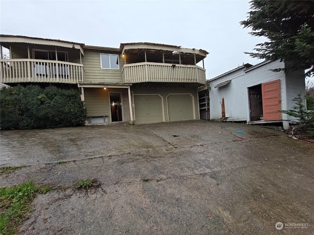 view of front of house with a balcony and a garage