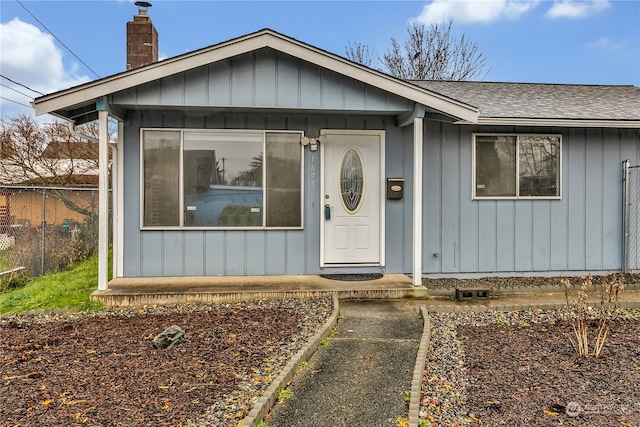 1675 S 57th St, Tacoma, WA 98408 - entrance to property with roof with shingles, a chimney, and board and batten siding