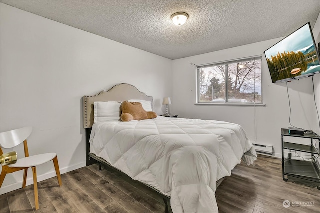 1675 S 57th St, Tacoma, WA 98408 - bedroom featuring a textured ceiling, wood finished floors, and a baseboard radiator
