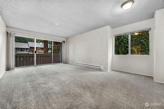 spare room with carpet, a baseboard radiator, and a textured ceiling