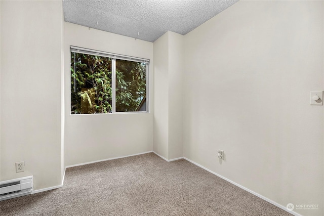 carpeted empty room featuring a baseboard radiator and a textured ceiling