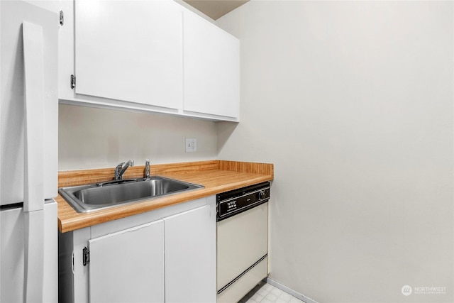 kitchen featuring white cabinetry, white appliances, and sink