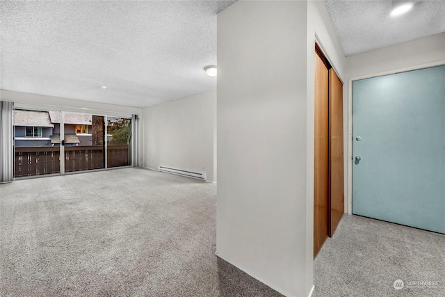 unfurnished living room featuring carpet, a textured ceiling, and a baseboard heating unit