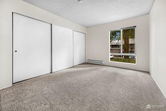 unfurnished bedroom with light carpet, a closet, a textured ceiling, and a baseboard heating unit