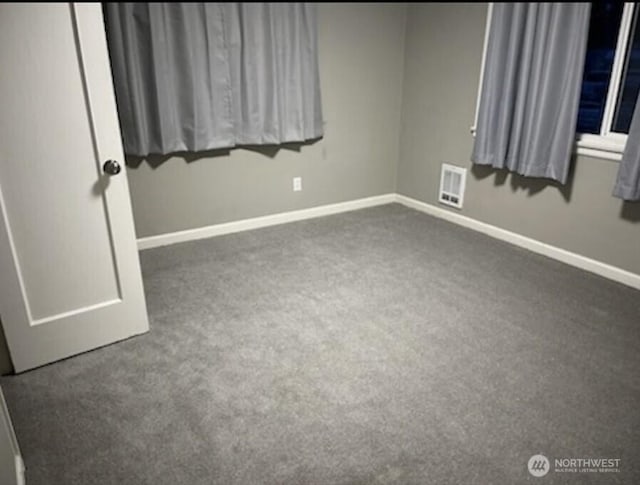 unfurnished bedroom featuring dark carpet