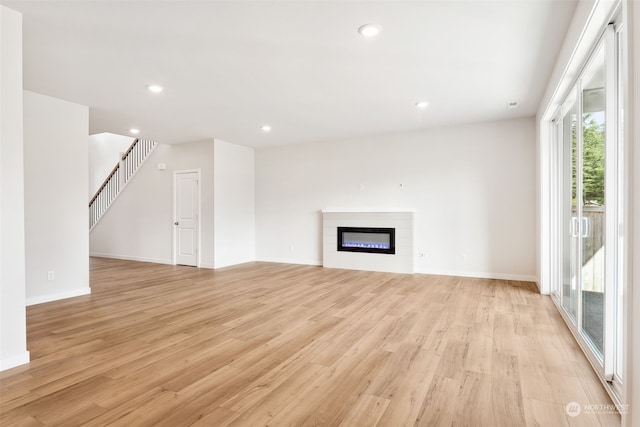 unfurnished living room featuring light wood-type flooring