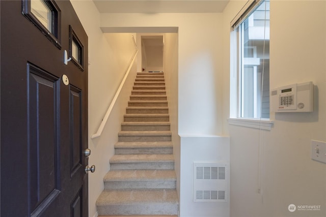 stairway featuring plenty of natural light