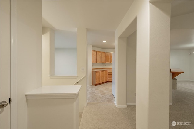 corridor with light colored carpet