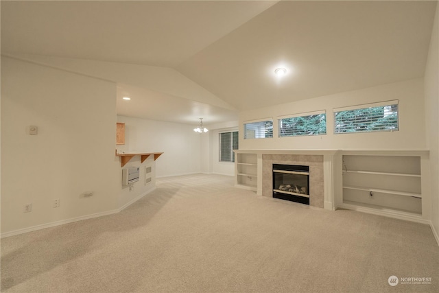 unfurnished living room with a tile fireplace, light colored carpet, built in features, and lofted ceiling