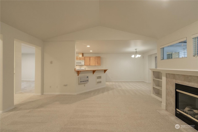 carpeted living room featuring a tiled fireplace, built in features, a chandelier, and lofted ceiling