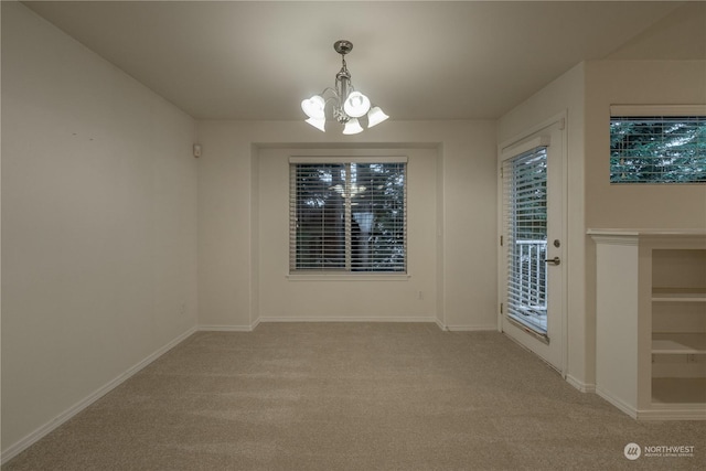 unfurnished dining area with light carpet and an inviting chandelier