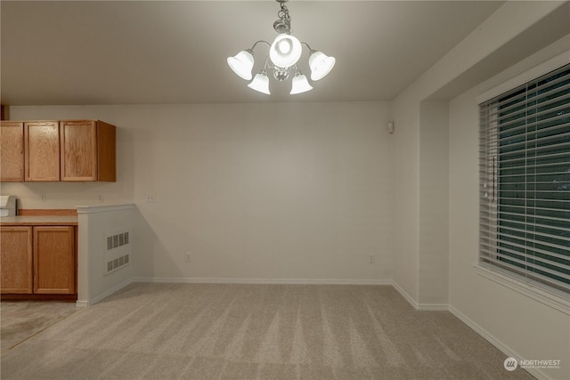 unfurnished dining area featuring light colored carpet and a chandelier