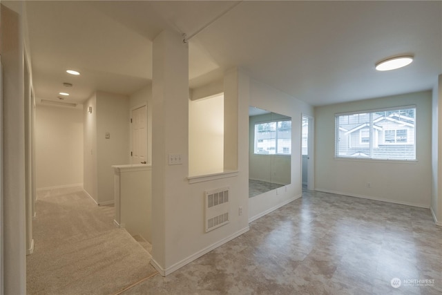 interior space featuring light carpet and plenty of natural light