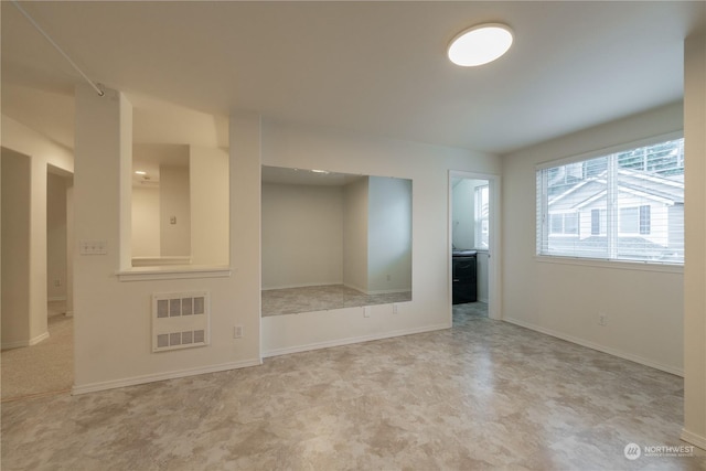 unfurnished room featuring radiator