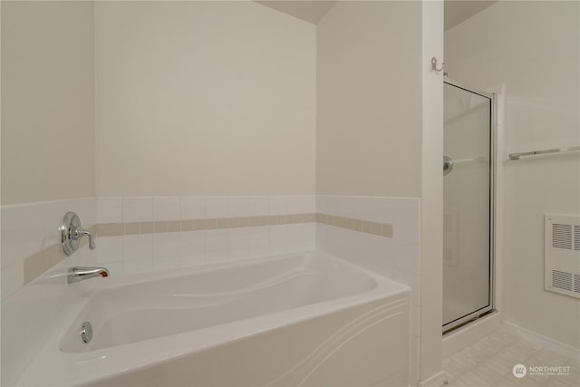 bathroom with heating unit and independent shower and bath