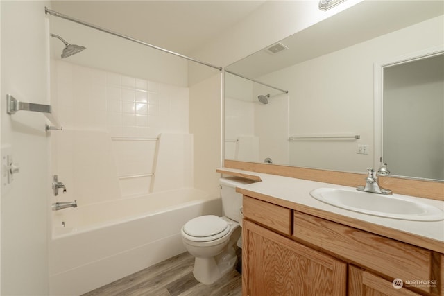 full bathroom with hardwood / wood-style floors, vanity, tub / shower combination, and toilet