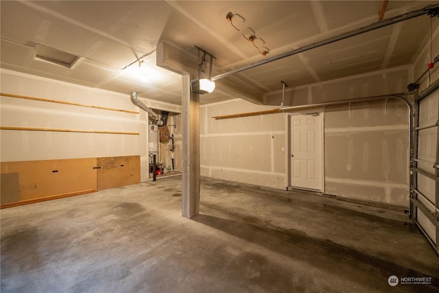 garage featuring gas water heater and a garage door opener