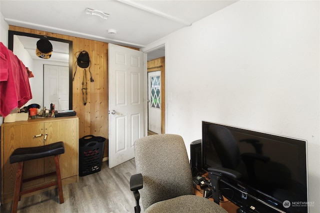 office space featuring wood-type flooring and wood walls