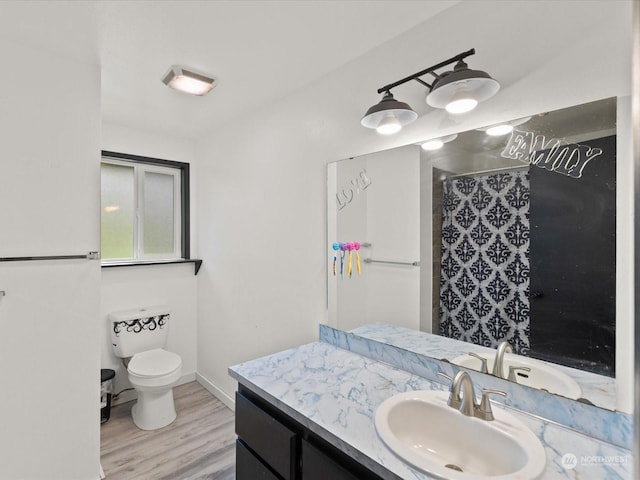 bathroom with wood-type flooring, vanity, toilet, and walk in shower