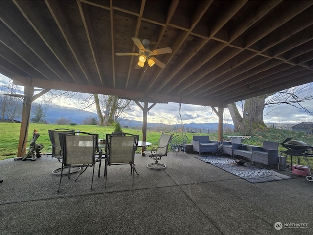 view of patio featuring a mountain view and ceiling fan