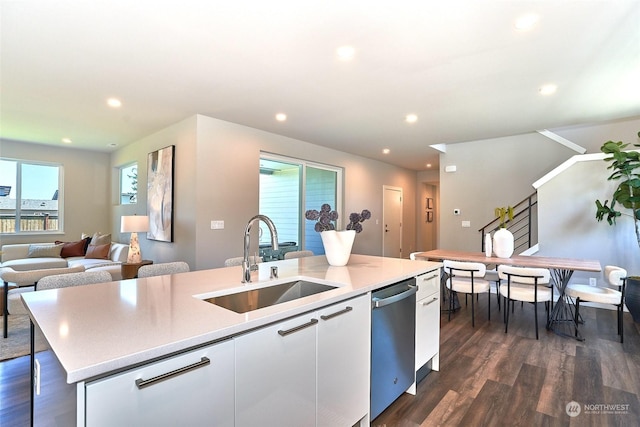 kitchen with sink, dishwasher, an island with sink, white cabinets, and dark hardwood / wood-style flooring