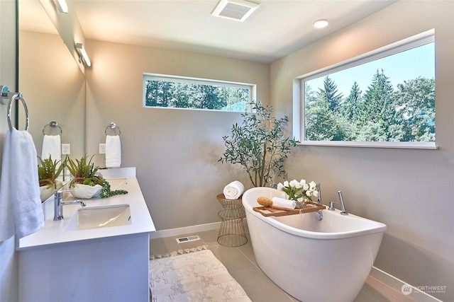 bathroom with vanity, tile patterned floors, and a tub