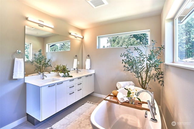 bathroom with vanity, tile patterned flooring, and a wealth of natural light