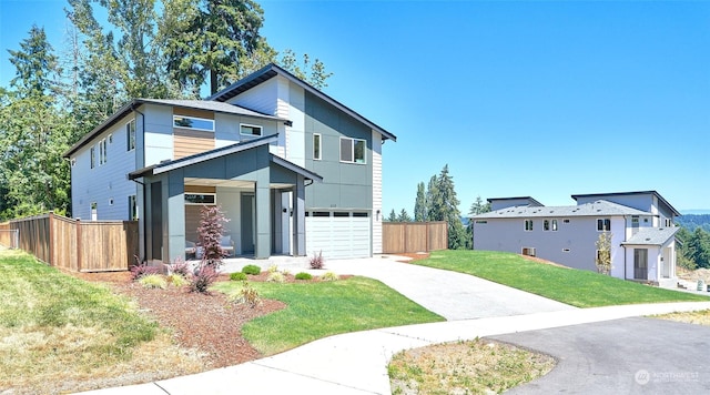 view of front of home featuring a garage and a front lawn