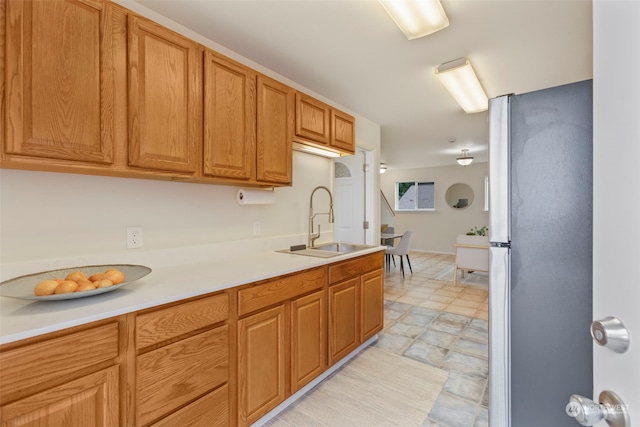 kitchen featuring stainless steel refrigerator and sink