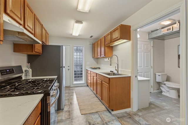 kitchen with stainless steel gas range oven and sink