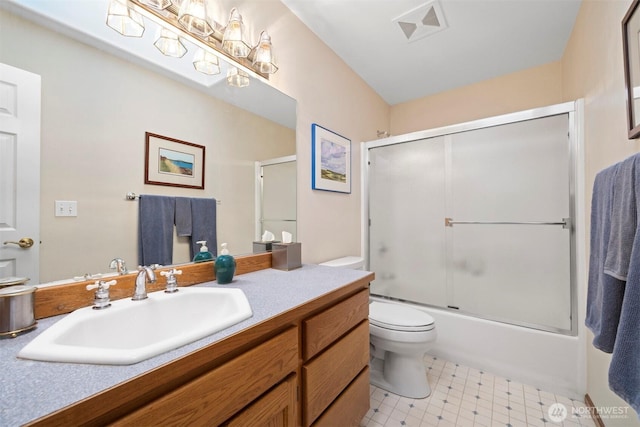 full bathroom featuring visible vents, bath / shower combo with glass door, toilet, tile patterned floors, and vanity