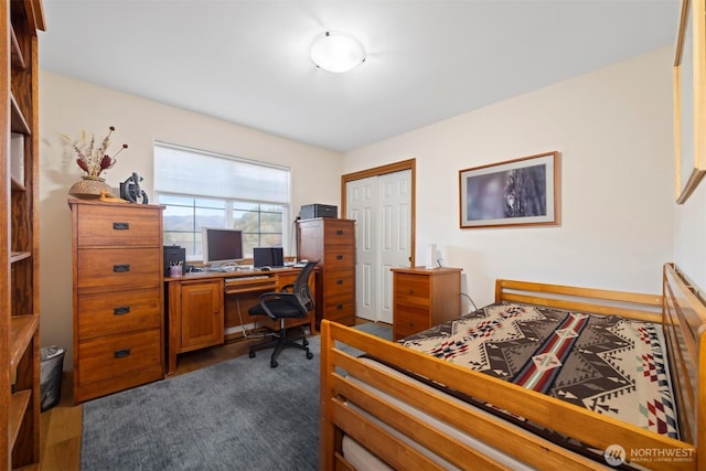 bedroom with a closet and dark wood-style flooring