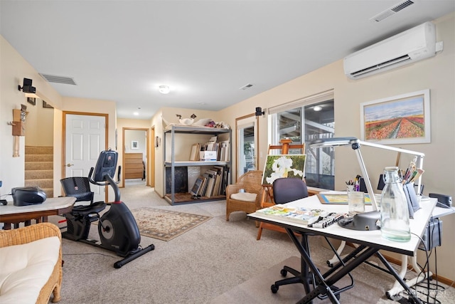 office with visible vents, a wall mounted air conditioner, and light carpet