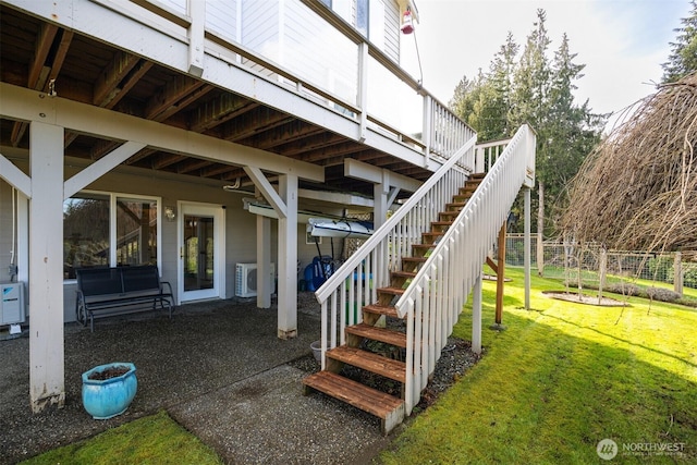 view of patio / terrace with stairs and washer / dryer