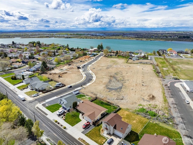 aerial perspective of suburban area featuring a nearby body of water