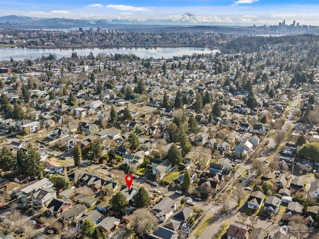 drone / aerial view with a water and mountain view