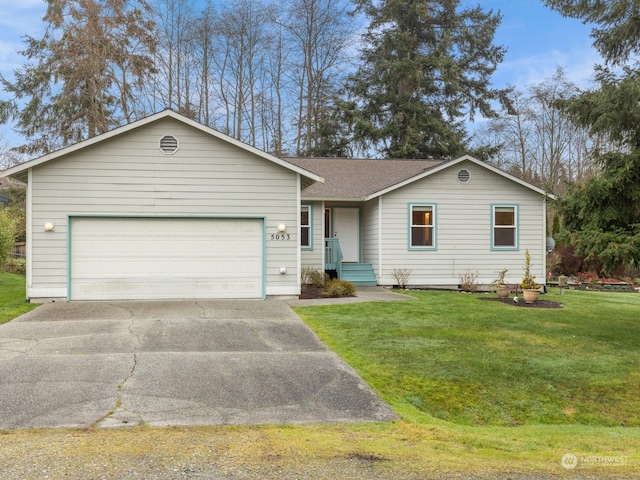 ranch-style house featuring a front yard and a garage