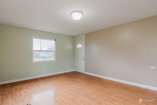 empty room with light hardwood / wood-style flooring