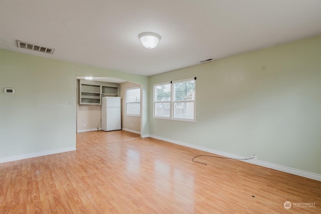 unfurnished room with light hardwood / wood-style flooring