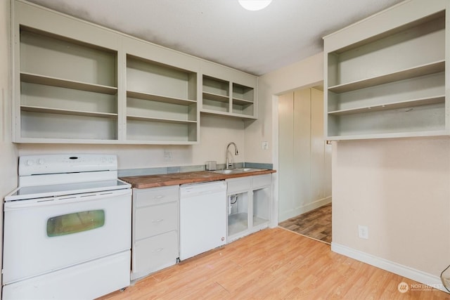 kitchen with wood counters, white appliances, sink, light wood-type flooring, and a textured ceiling