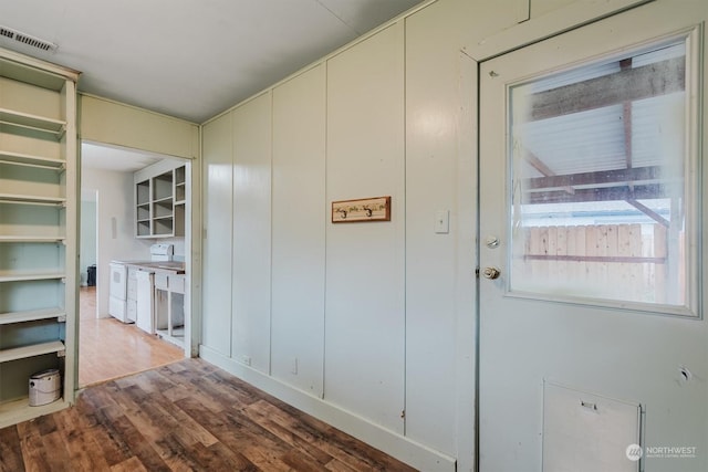 corridor featuring hardwood / wood-style floors and washer / clothes dryer