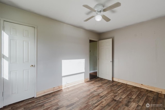 spare room with dark hardwood / wood-style floors and ceiling fan