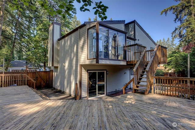 rear view of property featuring a deck