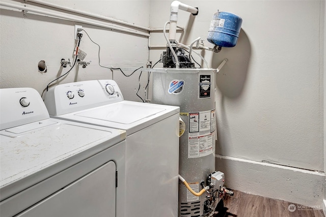 laundry area featuring gas water heater, wood-type flooring, and washing machine and clothes dryer